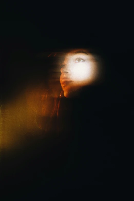 light is shining through the dark shadow of a woman's face