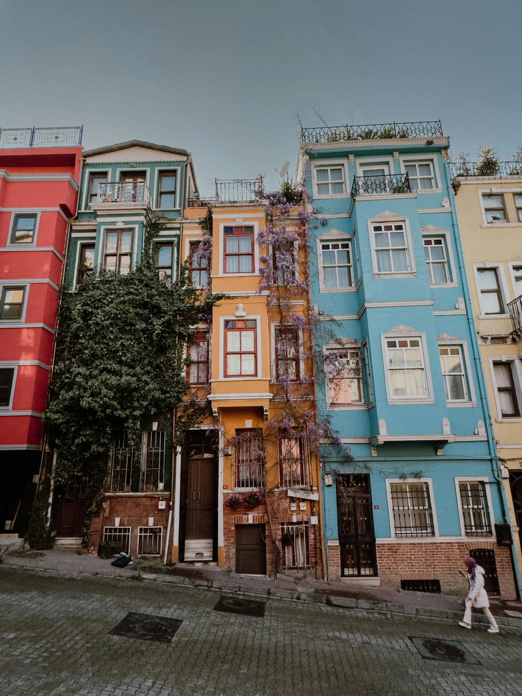 a city street with tall buildings and people walking in it