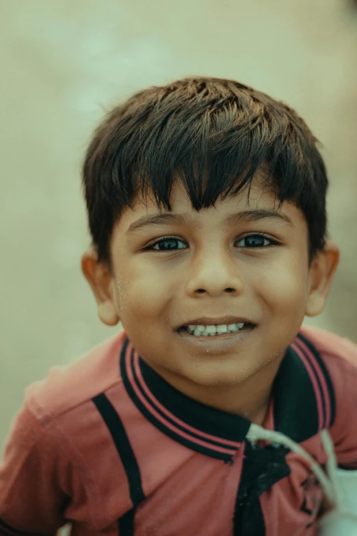 a close up of a young child smiling