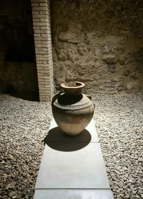 the large pottery is on display in a room with stone walls