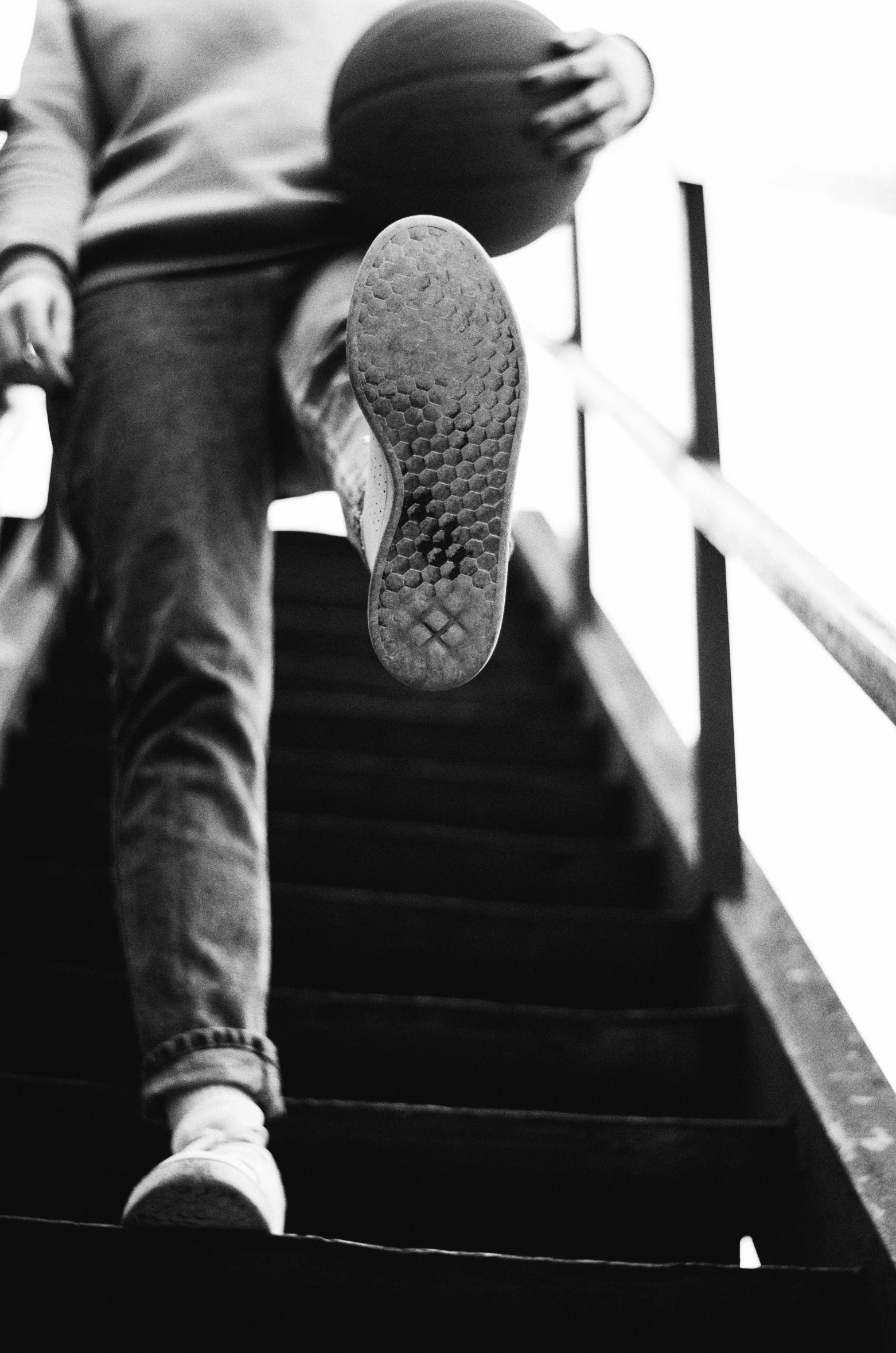 the foot is placed over the top of the hand rail