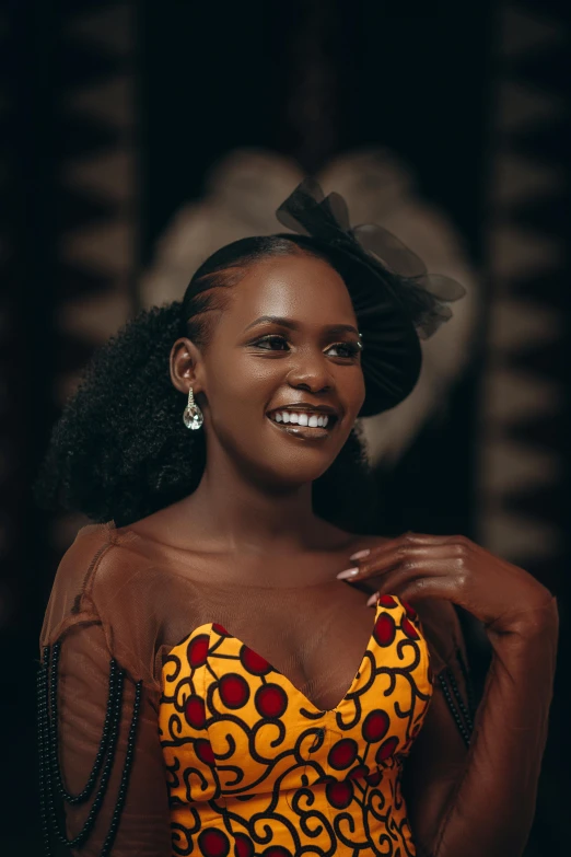 a woman with black hair and wearing a patterned blouse and smiling