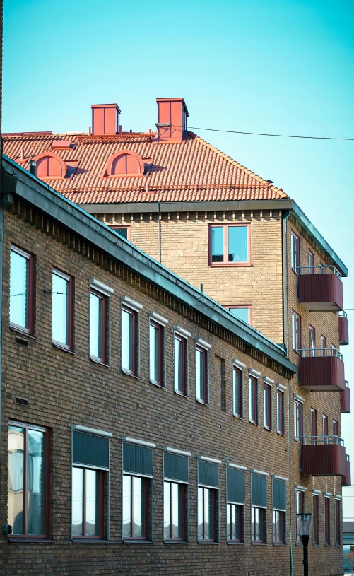 brick building with red tiled roof with windows and windows