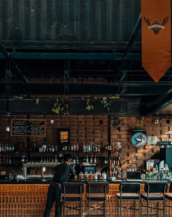 the bartender is behind the bar waiting for customers to come