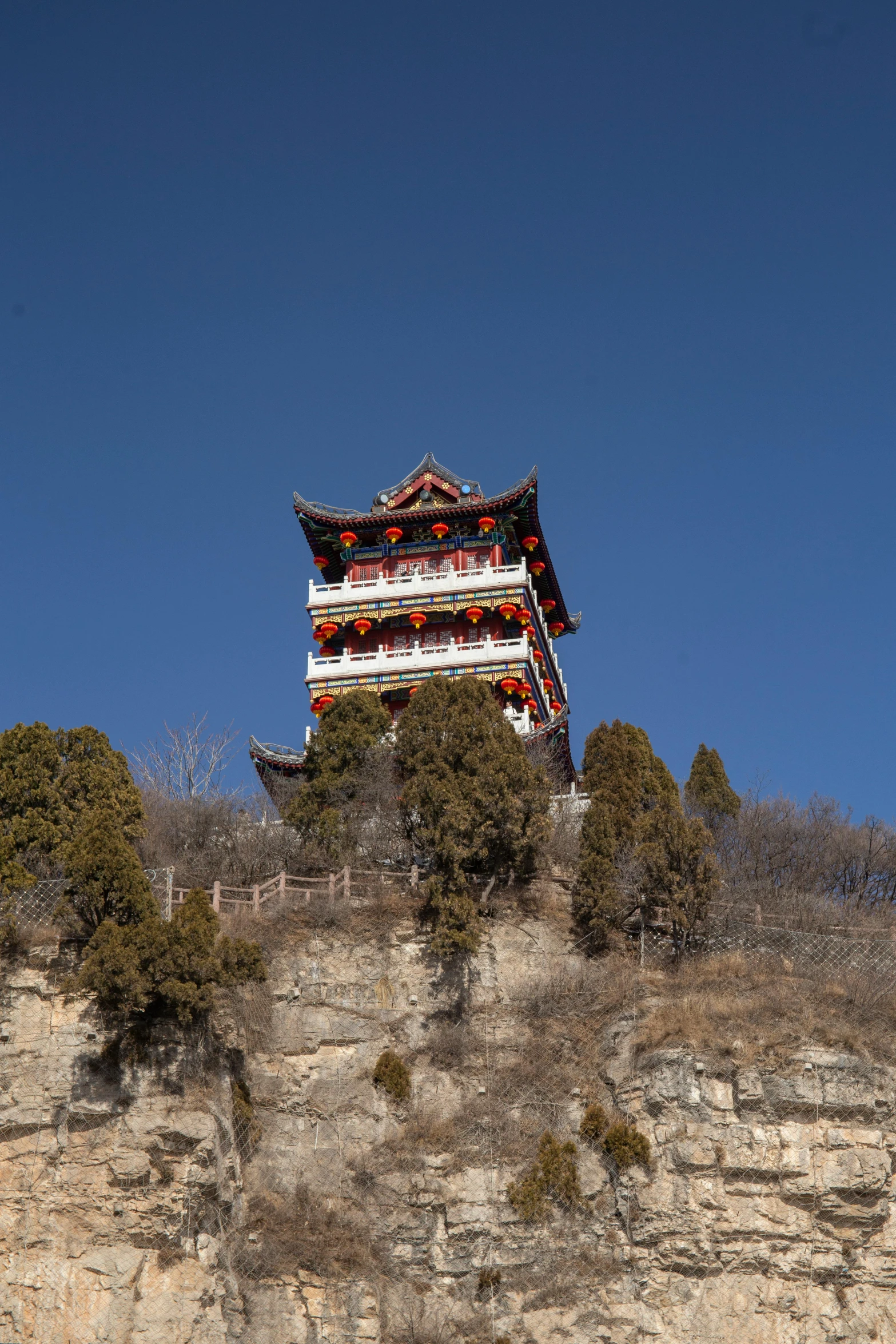 a tall building is sitting atop a cliff