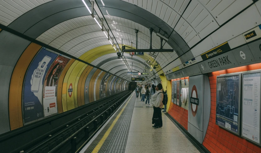 a train station with a man pulling a luggage cart