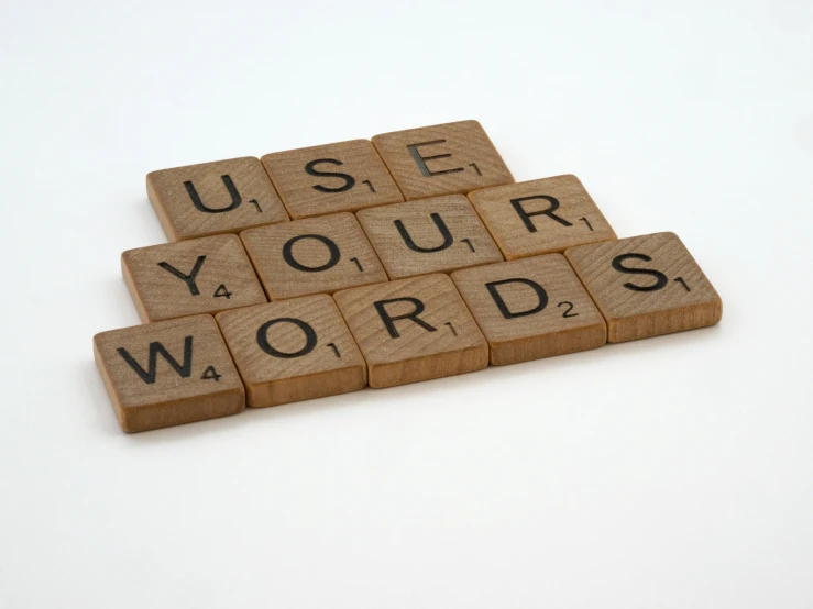 four scrabble tiles placed together with words used for word wordpress