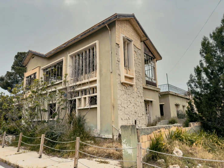 an old building with multiple balconies next to a fence