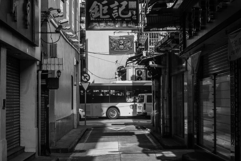 an alley way with signage hanging from the side