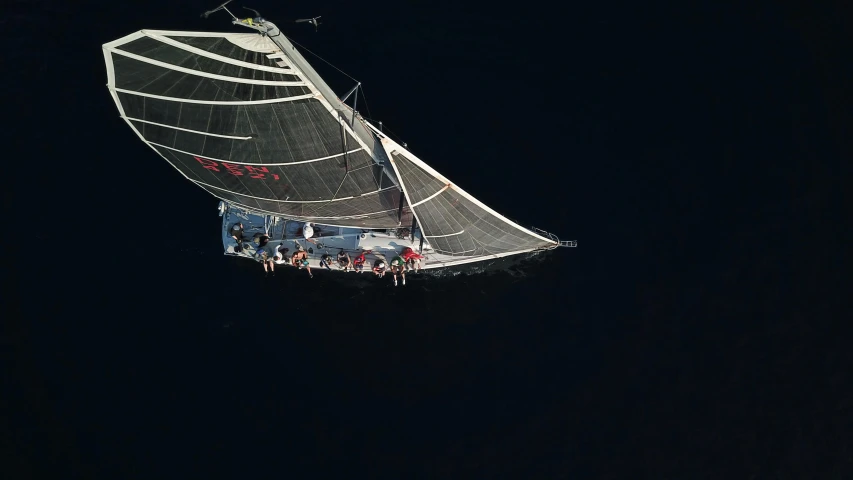 a group of people are in the water, while one person windsurfing