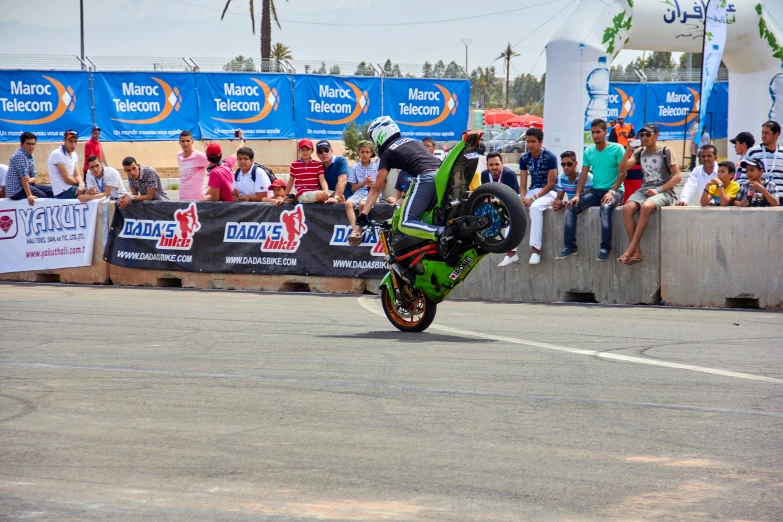 a motorcyclist is jumping a turn on a road