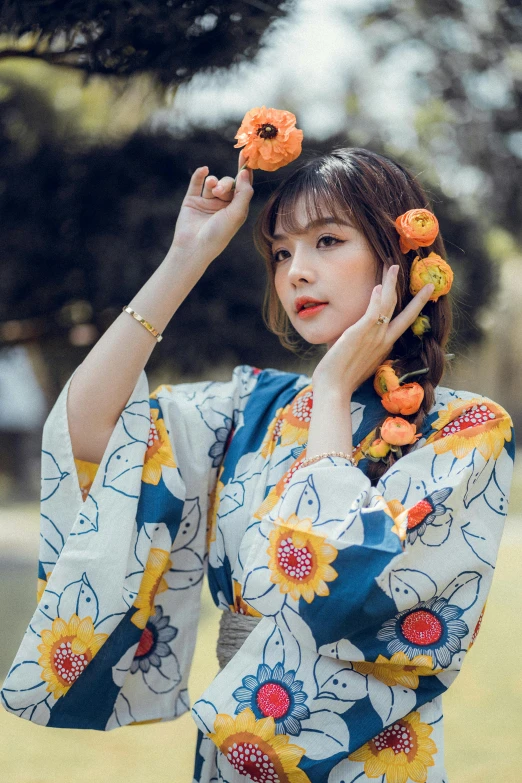 a beautiful young woman posing with flower hair clips