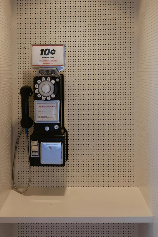 a telephone in a corner next to a package for $ 10