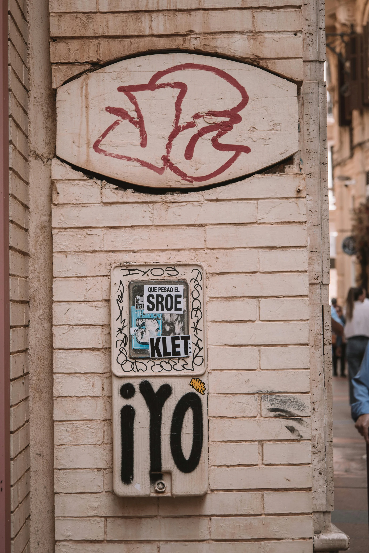 street art graffiti on a building wall with another street sign