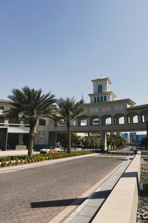 a clock tower sitting next to a couple of palm trees