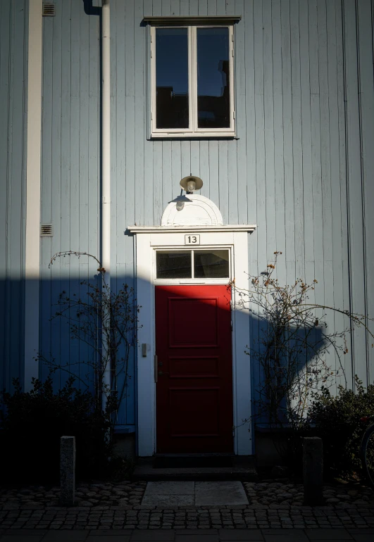 a red door in front of an older building