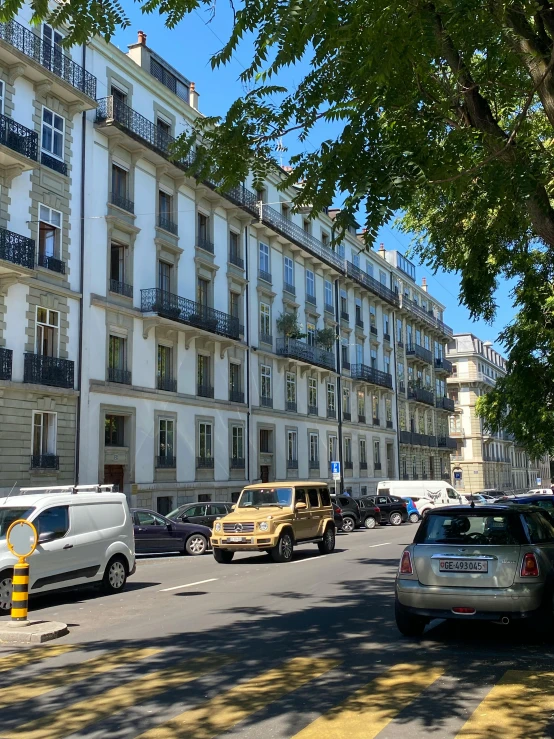 a number of cars near a large building with balconies