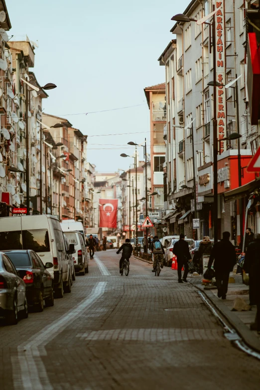 the street is lined with cars and people in chinatown