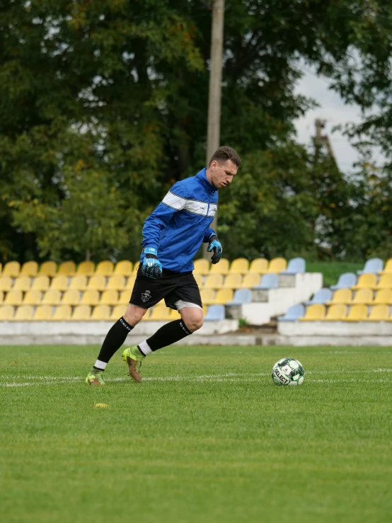 a young man on the soccer field about to kick the ball