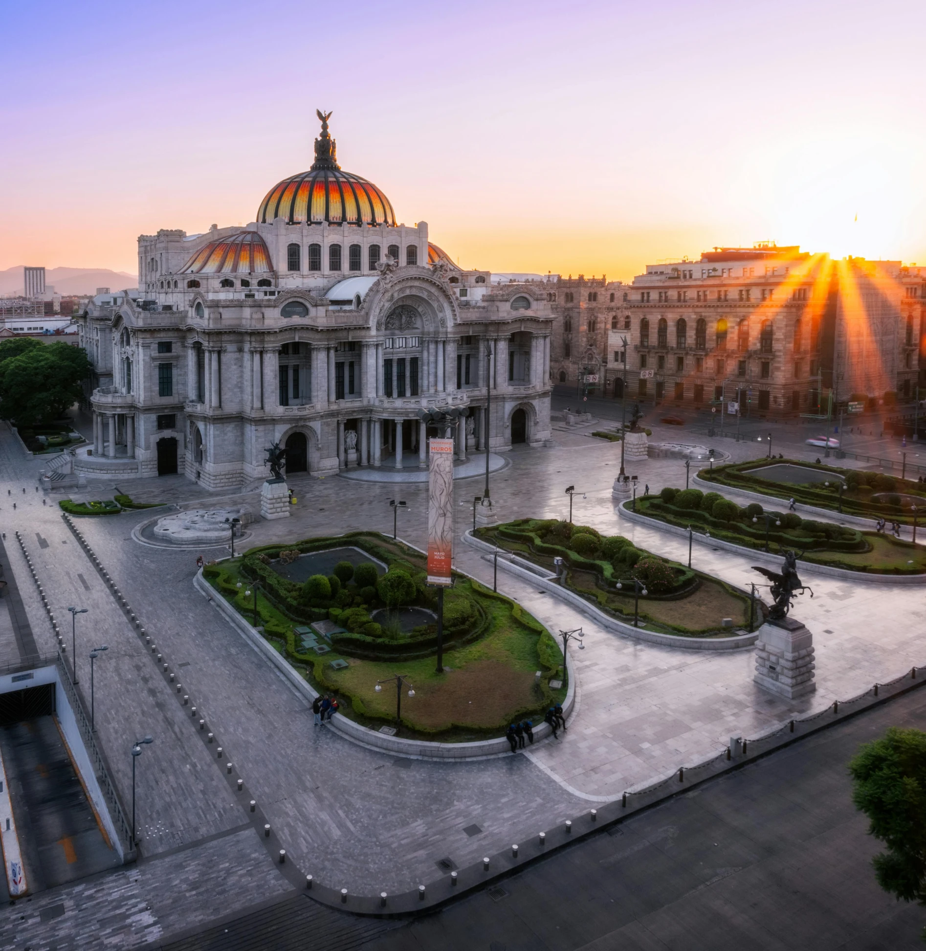 an ornate building at sunset with the sun coming up in the background