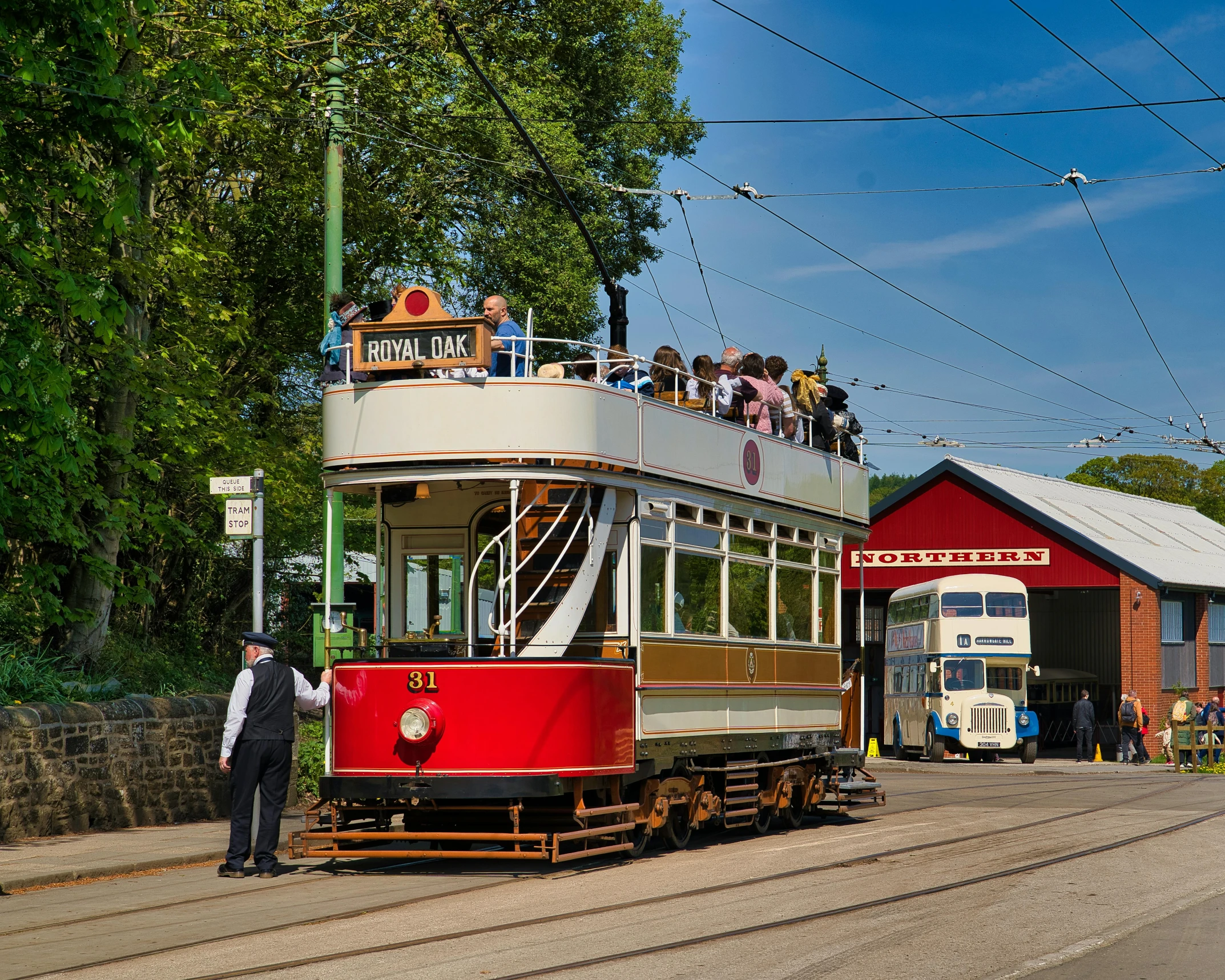 a trolley car is full of passengers down a hill