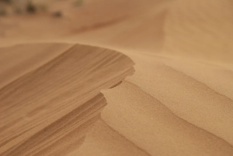 a view of a brown sand dune that is in the desert