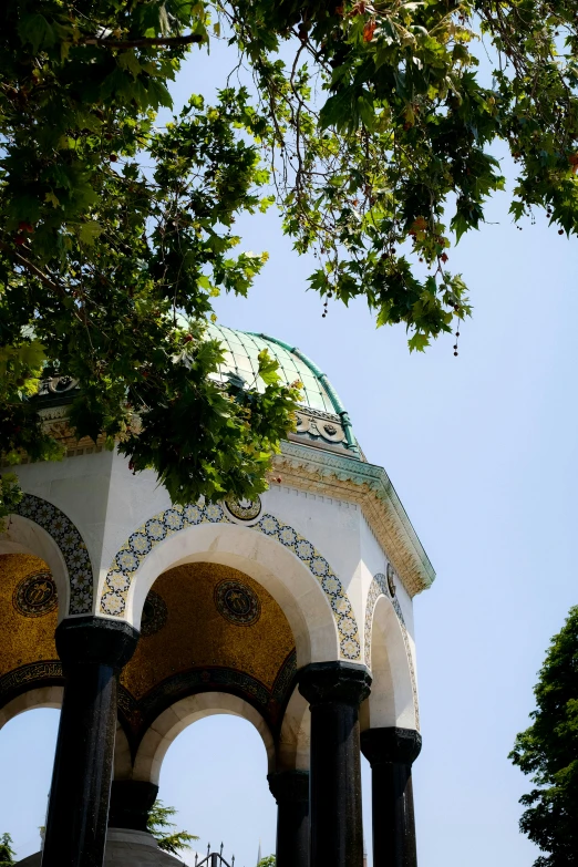 the clock tower has pillars and arches with clocks