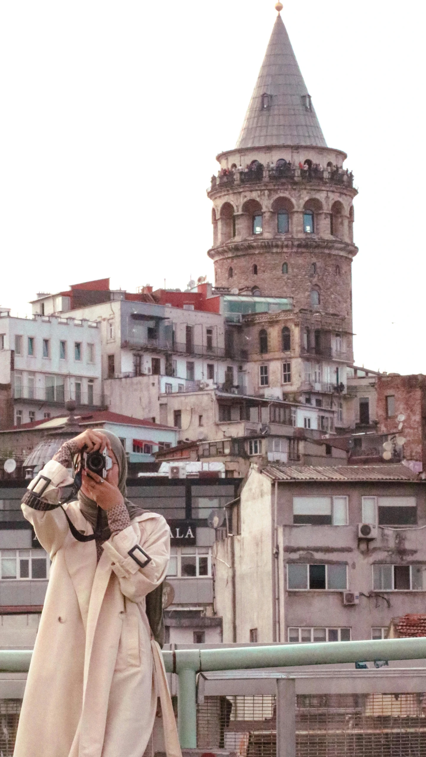 the man is taking a picture in his old coat