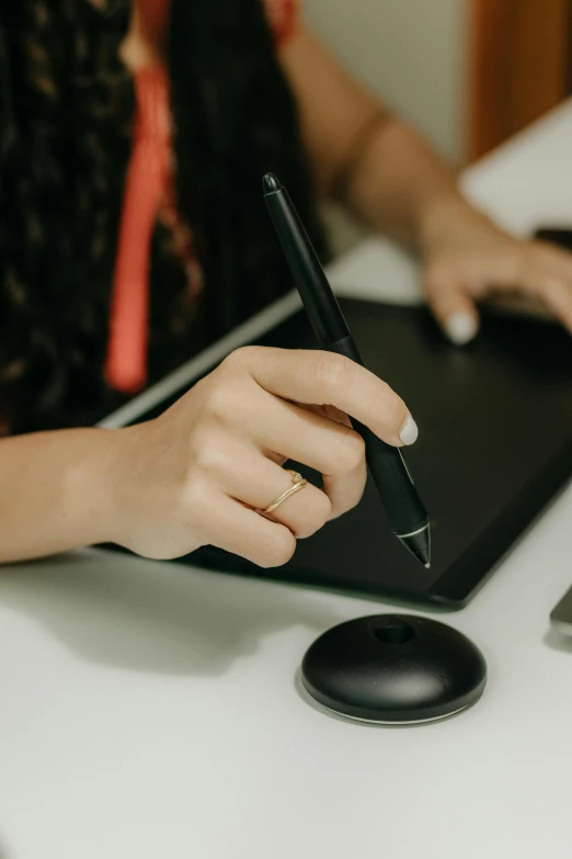 a woman using a laptop computer while writing