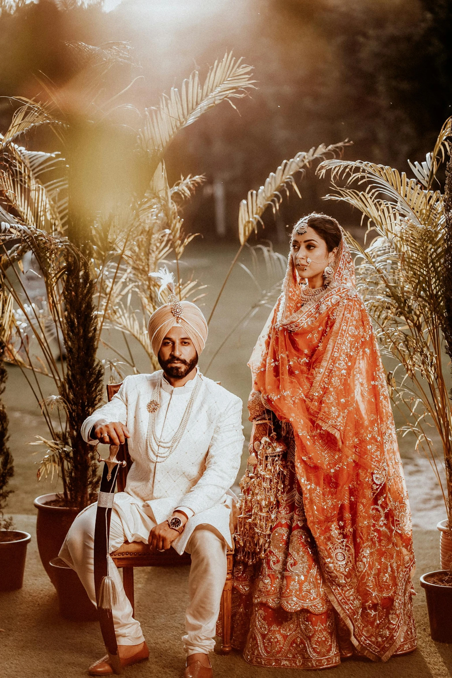 a couple poses for a po in their wedding attire