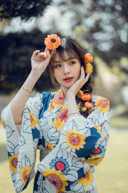 a woman in a kimono with sunflowers on her head