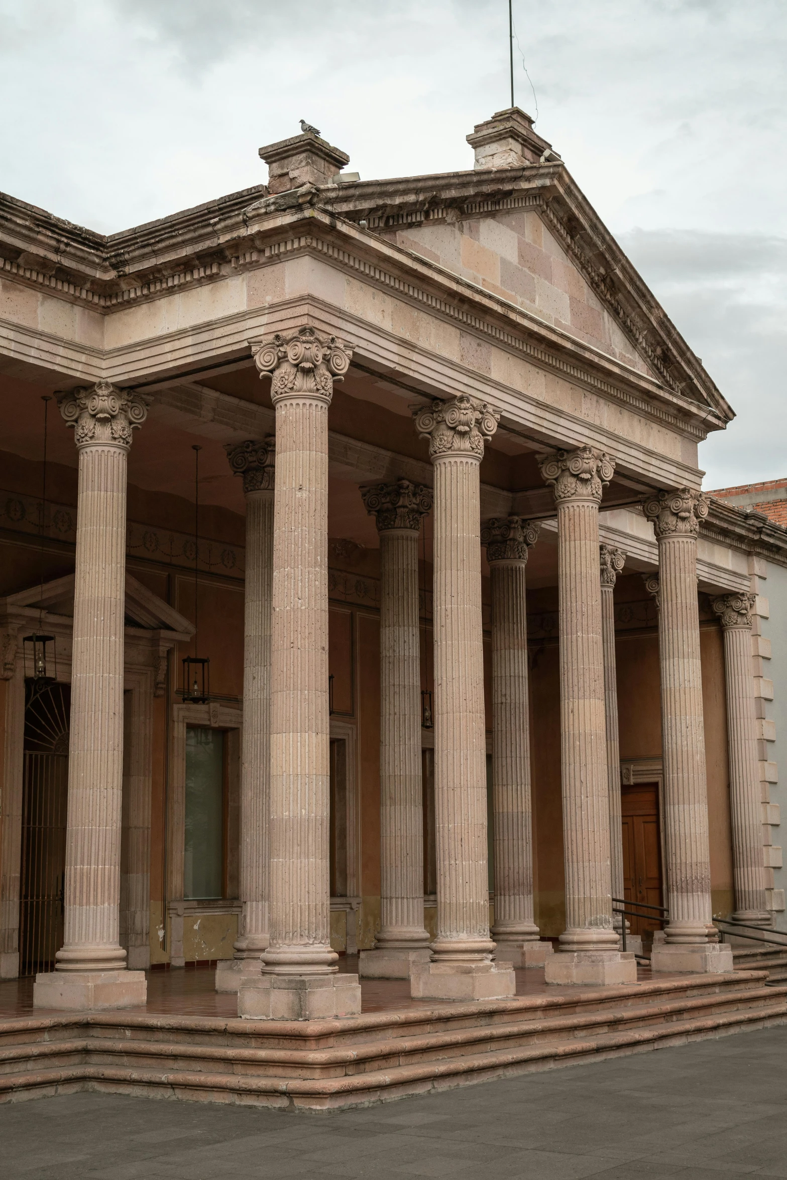 a building with columns, and a flag on top