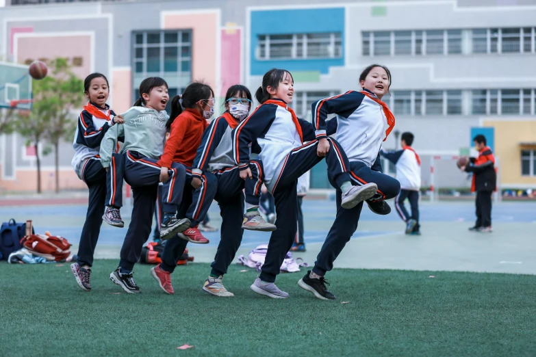 a group of girls are running on a basketball court