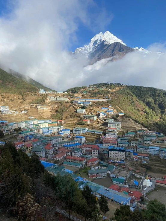 view of some very colorful village, with a mountain in the background