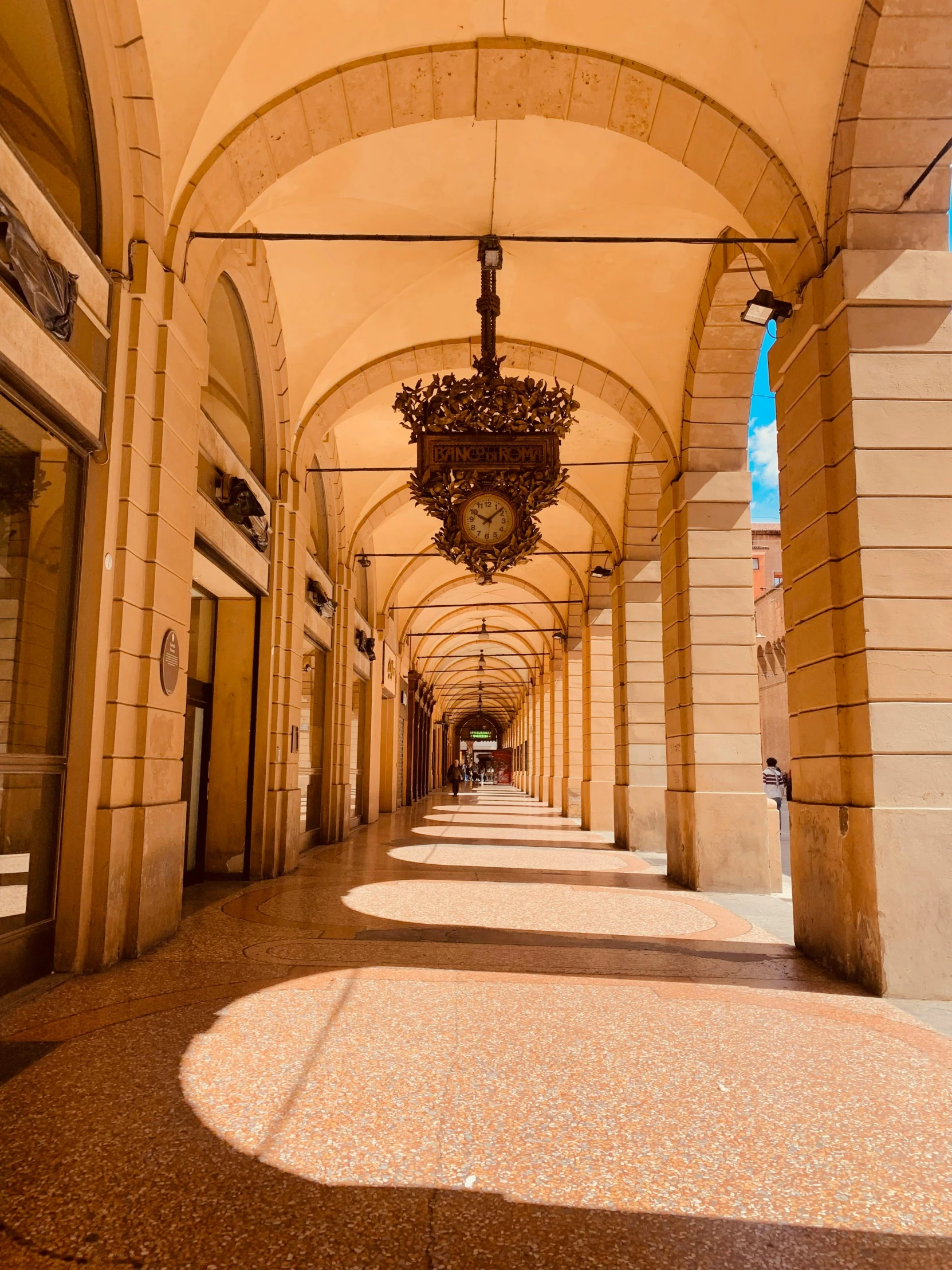 a walkway has hanging lights along the sides of it