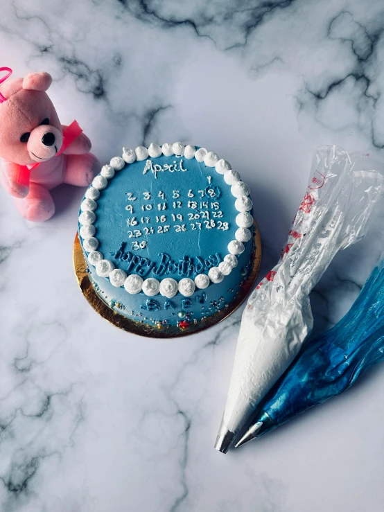 a birthday cake next to two plastic balloons