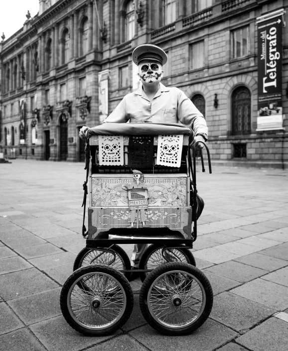 a man dressed as a military officer pulling a stroller with two wheels