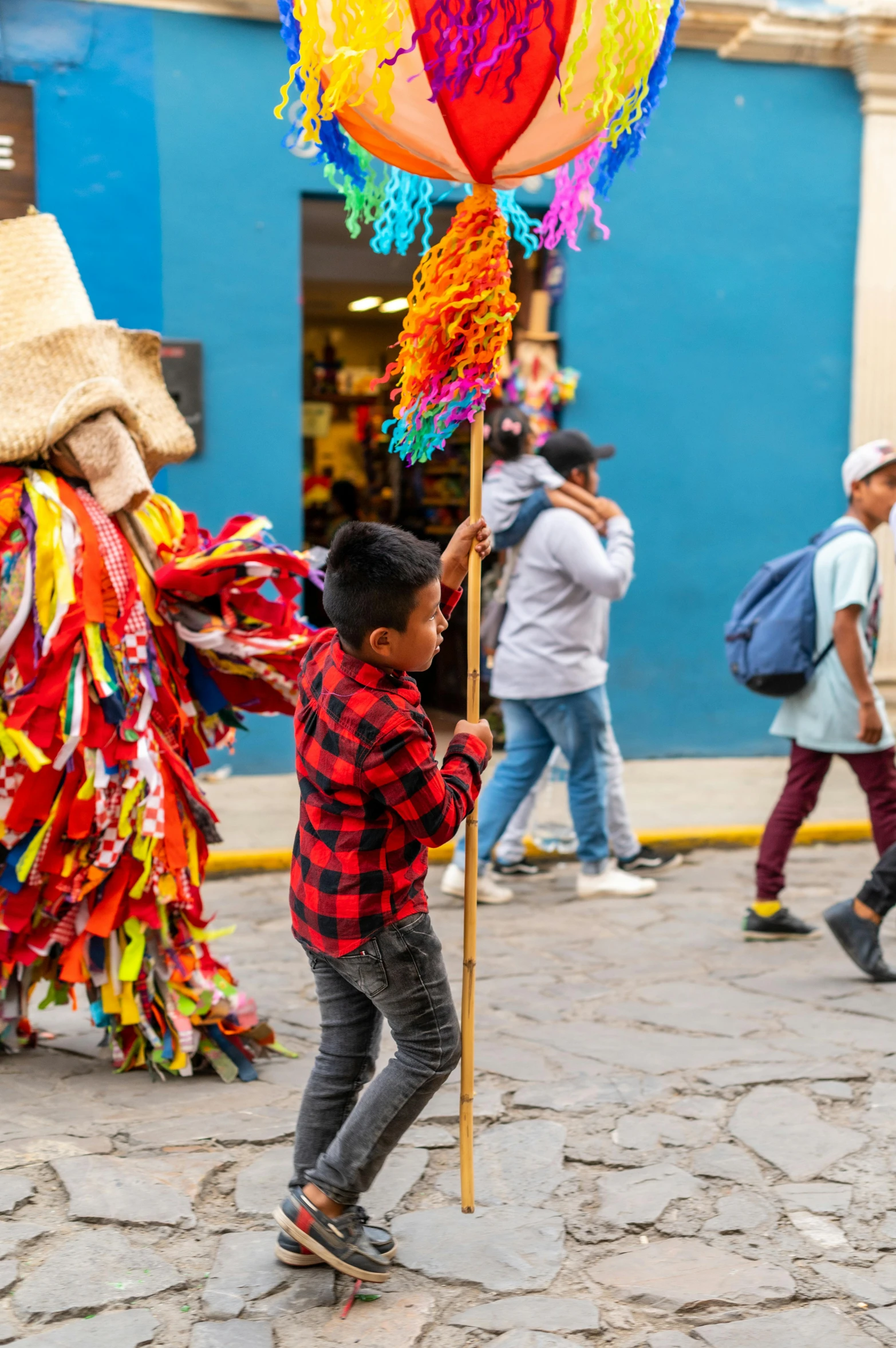 the child is holding a very colorful balloon