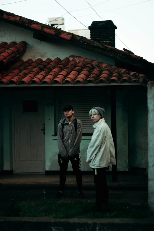 two older people standing outside of a building