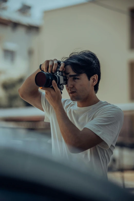 man using the camera in the parking lot of his home