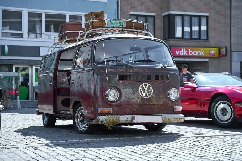a vintage van and a car parked in front of a business