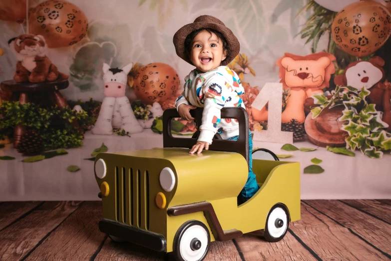 a young child in a hat rides a yellow truck