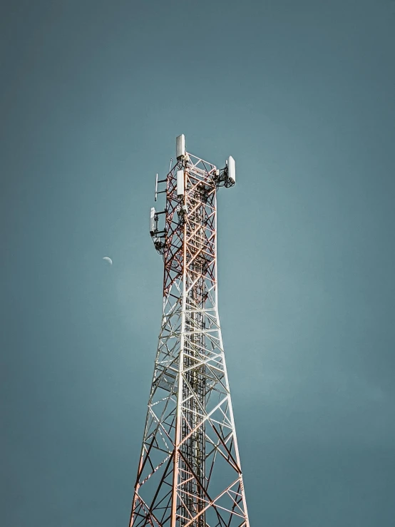 tall antennas sitting on the side of a metal structure