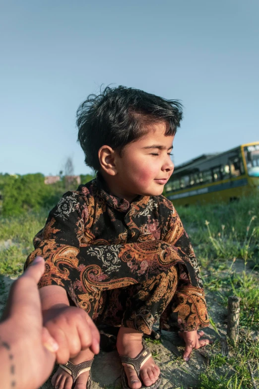 a person on the ground with a train in the background