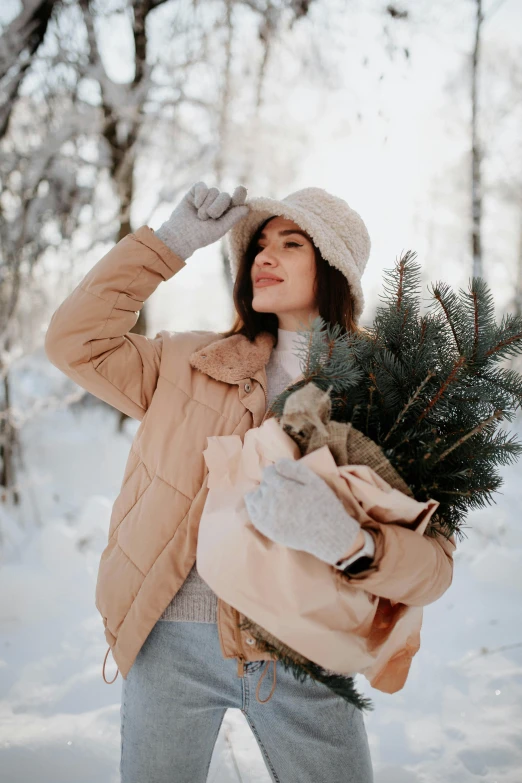 woman in winter coat walking through snowy area