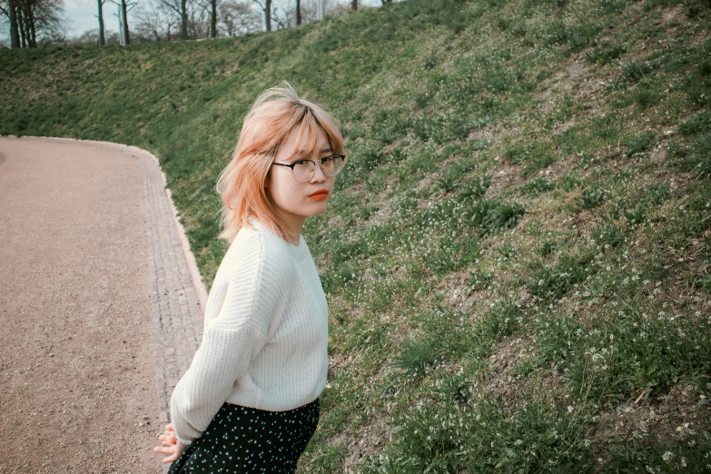 a woman in black polka dot pants wearing glasses