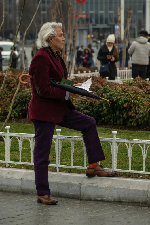 man walking on the sidewalk in a red blazer