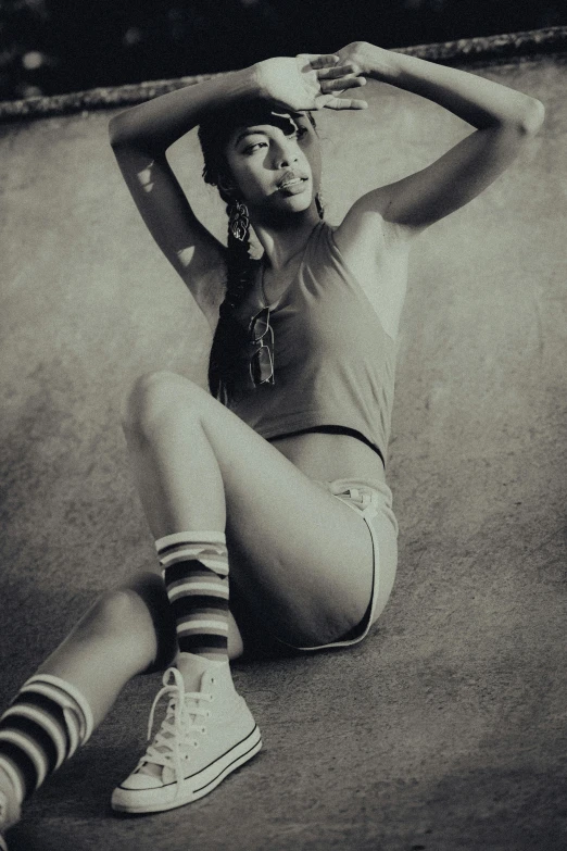 a woman sitting on the side of a basketball court with her hands to the head