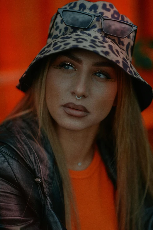 a young woman wearing a leopard print hat