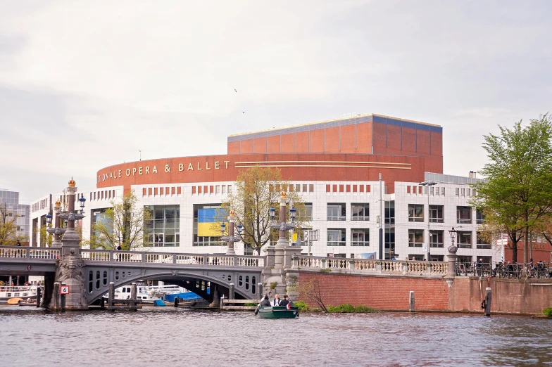 there is a building and some cars that are by the water